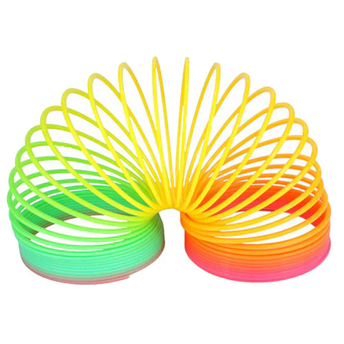 A colorful object. It is an arced shape, starting as green on the left, yellow in the middle, and pink on the right. It makes several loops or rings throughout the arc.