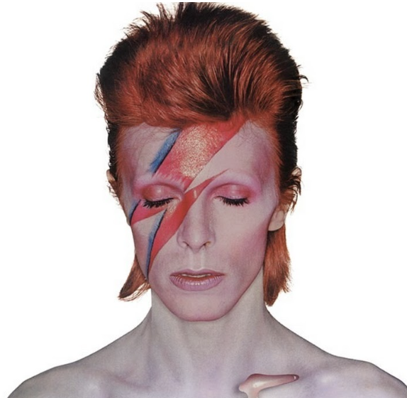 A photo of a person with red hair and a red-and-blue lighting bolt shape on their face.